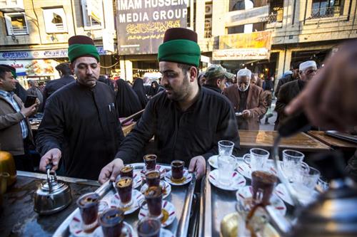 The Sayeds servants present tea to the visitors in the martyrdom anniversary of Fatima Az-Zahra(PBUH) near the al-Abbas Holy Shrine(PBUH).
